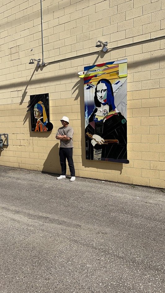 Peter standing next to ski art murals